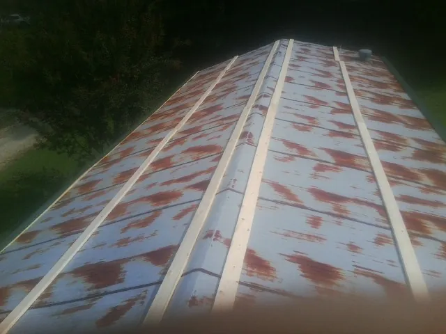 Rusted metal roof panels with new wood purlins before replacement — Storm Damage Roof Repair in Fredonia by Roofing Brothers